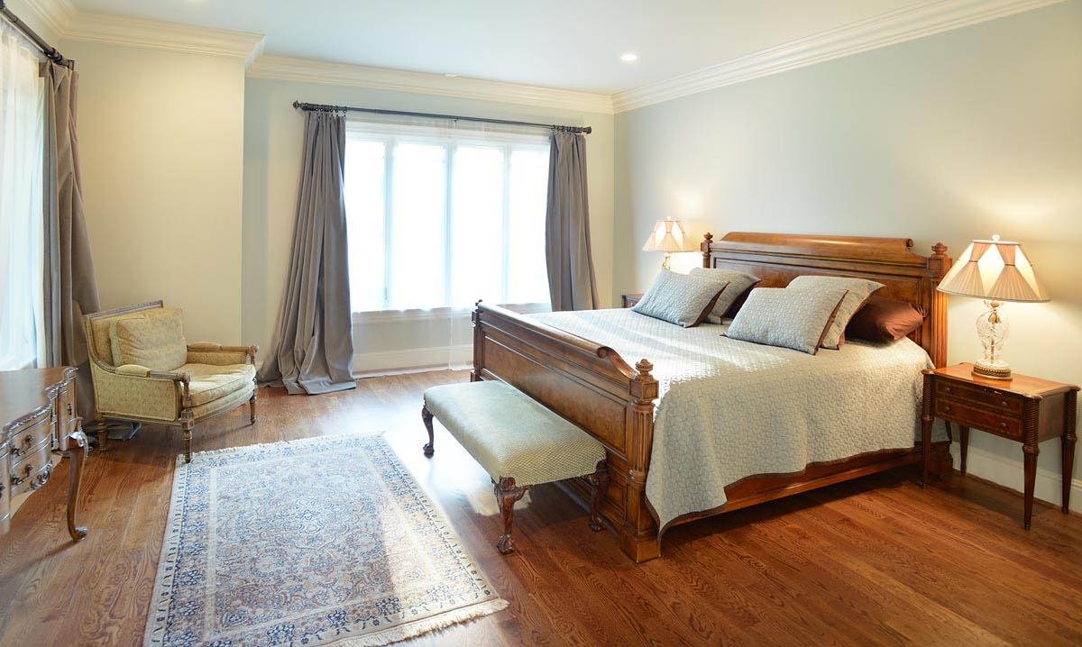 "Luxurious, eco-friendly bedroom in a Nashville home by Mossy Ridge, with organic linen, natural lighting, and a high-efficiency air filtration system.